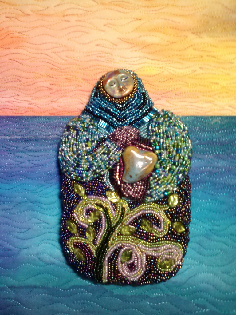 Mother Nurture, detail shot, by Beth Ann Williams. Sea & sky background painted on PDF fabric.