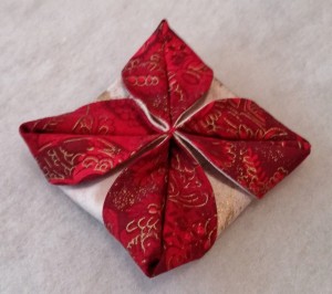 Gently manipulate the folded fabric "petals" until they are more or less equal in size.